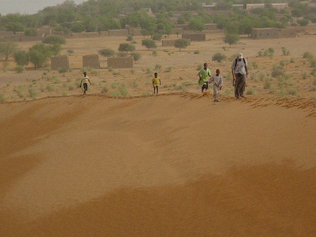 Climb the Pink Dune at sunset with local children in tow